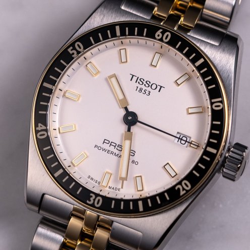 two-tone Tissot PR516 Powermatic 80 flat lay