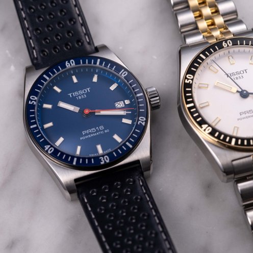 blue-dial and two-tone Tissot PR516 Powermatic 80 flat lay